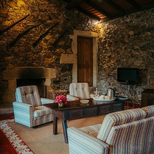 a living room with a striped couch and chairs