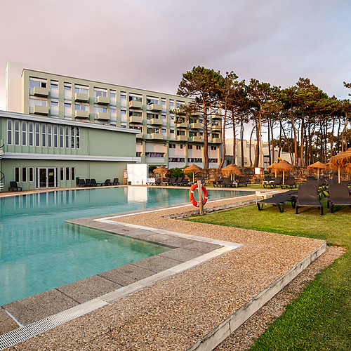 Hotel con piscina exterior y césped con tumbonas, perfecto para tu estadía Axis: Corporate.
