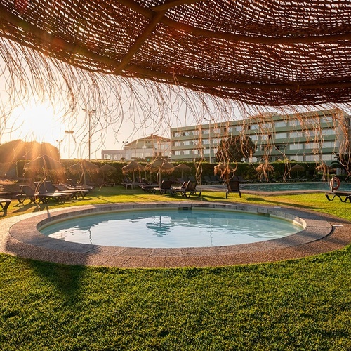 a swimming pool with a large building in the background