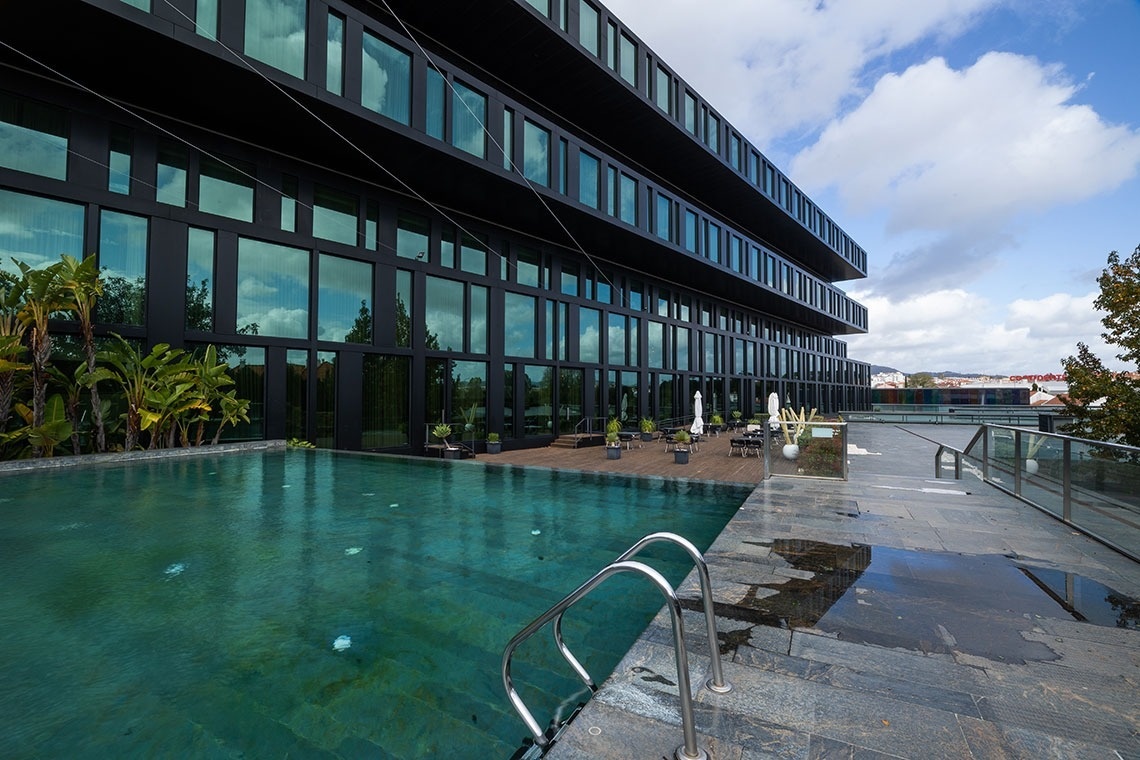 a large building with a swimming pool in front of it