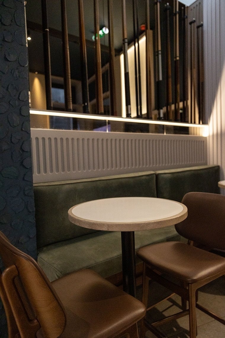 a table and chairs in a room with a green couch