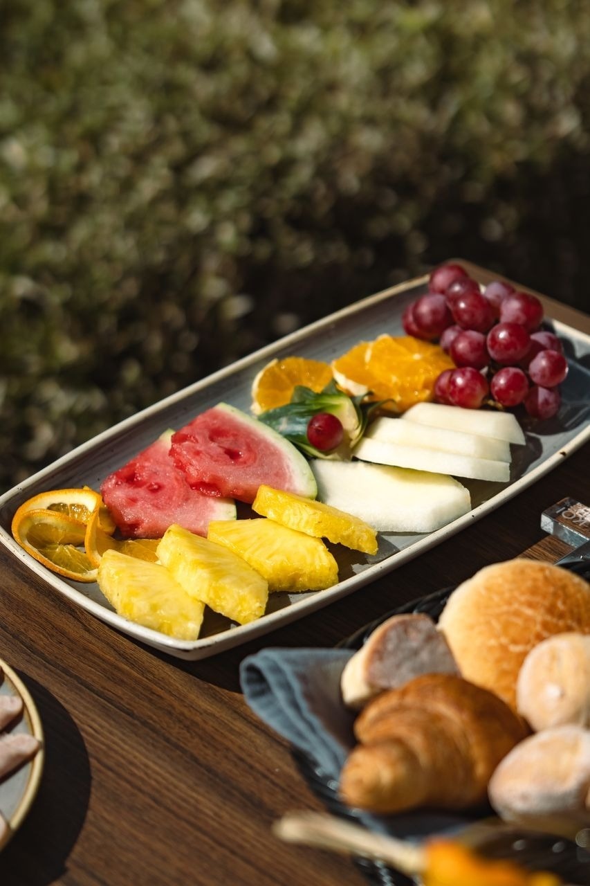 a plate of fruit and bread on a table