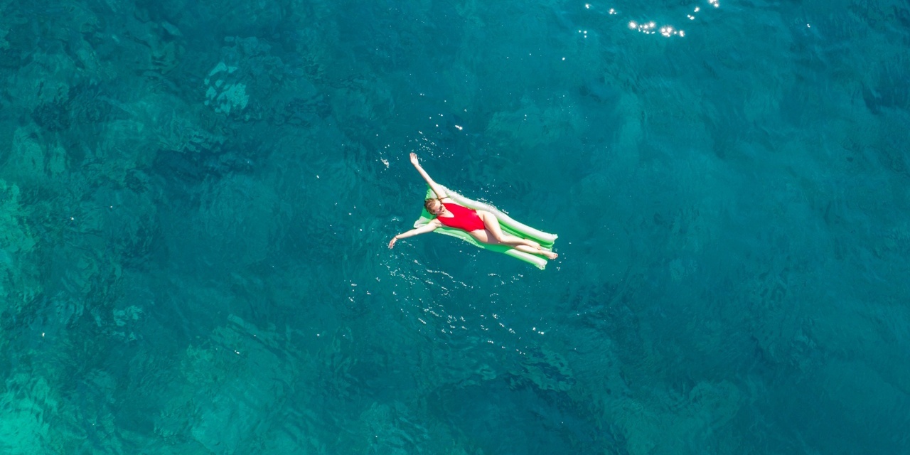 Woman on inflatable raft in azure waters | Azoris Hotels