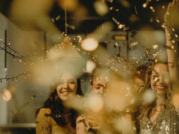 um grupo de pessoas está comemorando com confete e luzes .