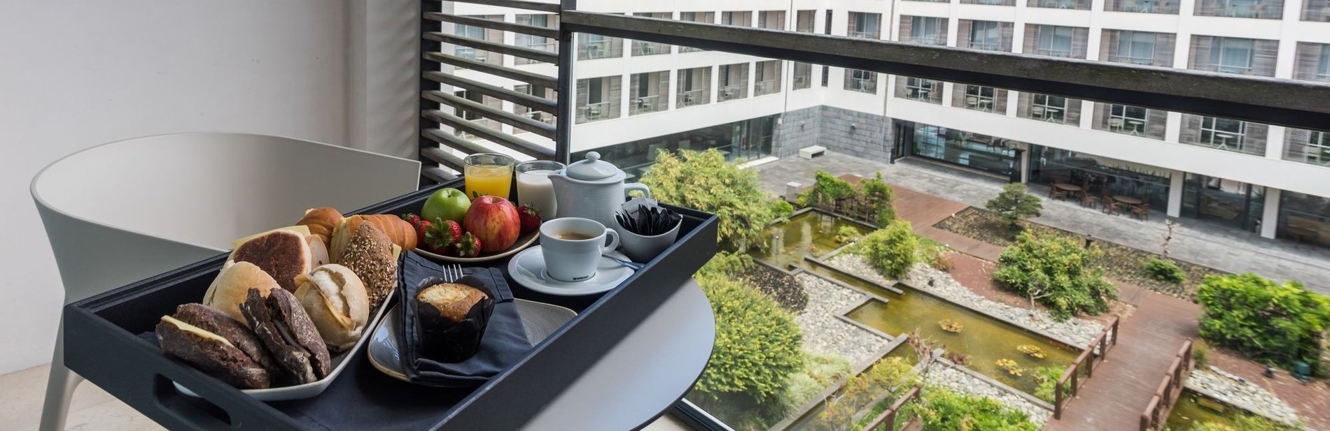 a tray of food sits on a balcony in front of a building