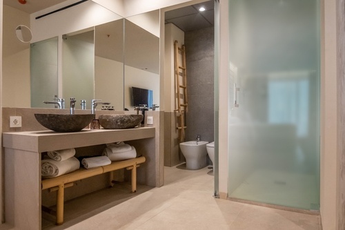 a bathroom with two sinks and a bidet
