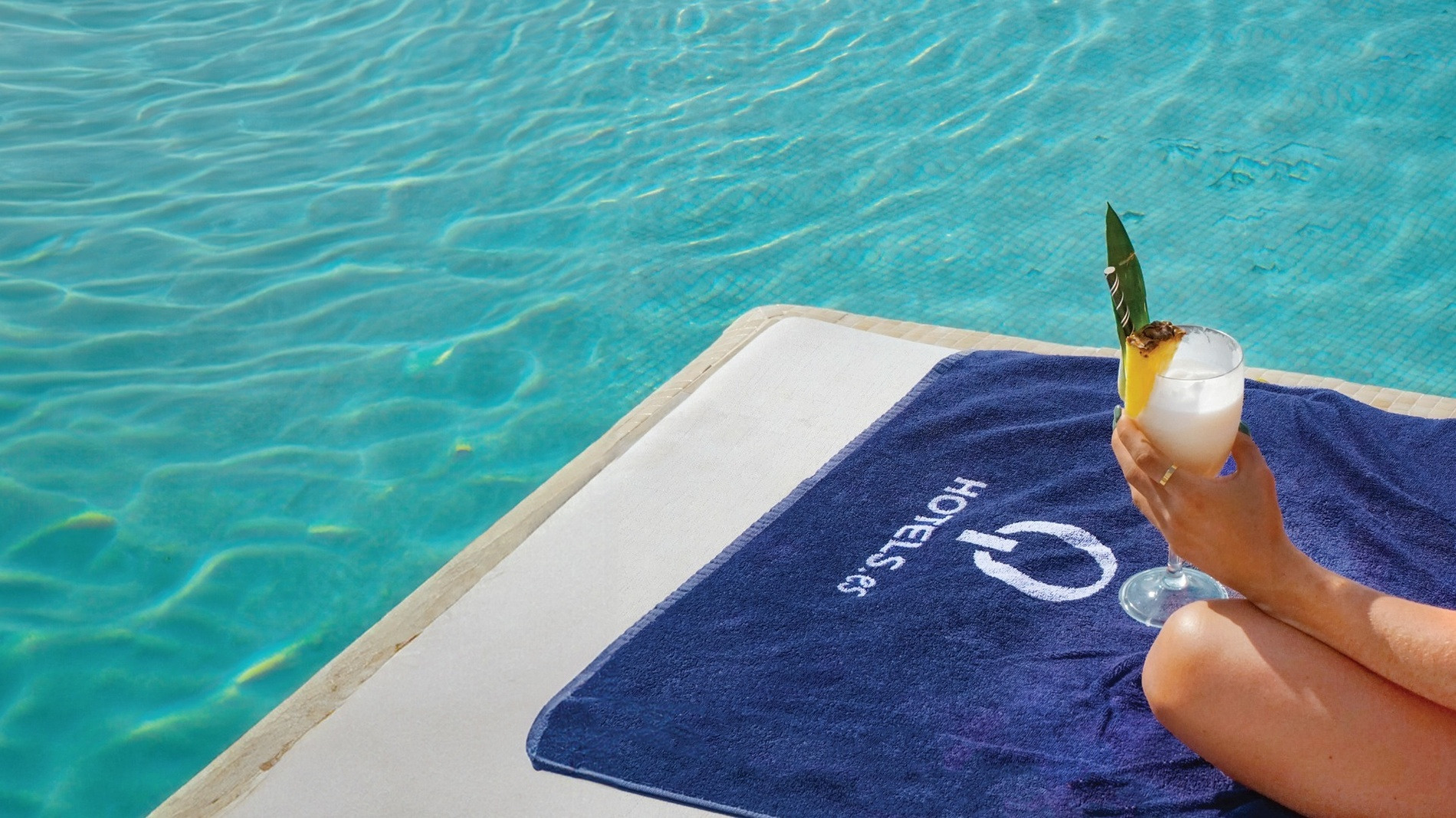 Enjoy a poolside cocktail with QHotels Corporativa towel.