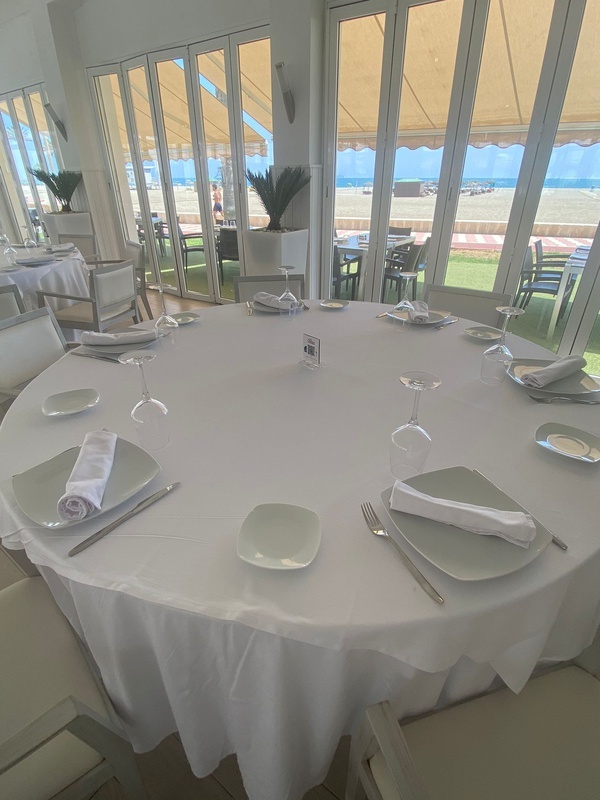 una mesa redonda con platos y copas en un restaurante