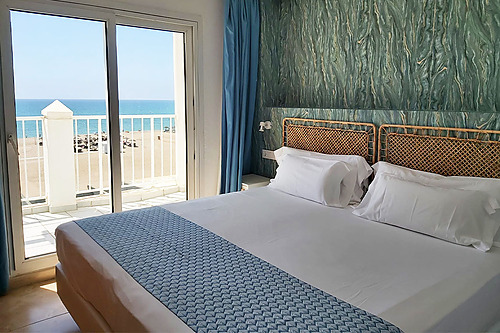 Bright Bahia Serena guest room featuring a comfy bed, balcony, and modern blue accents.