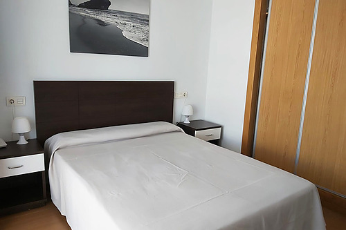 Comfortable Bahia Serena apartment living room with sofa, dining area, and modern decor.