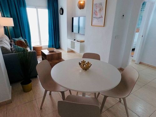 a living room with a round table and chairs