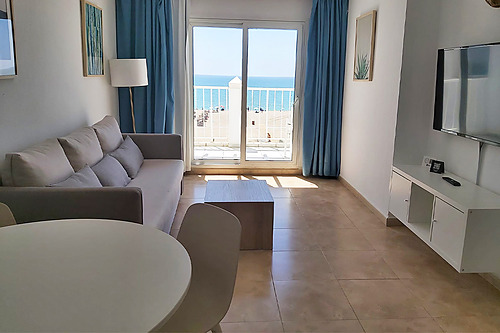 Modern living room with sofa, coffee table, and balcony Bahia Serena with ocean view.