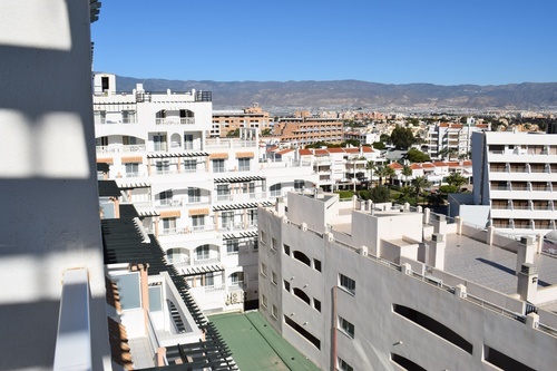 a view of a city with mountains in the background