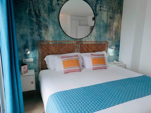 una habitación de hotel con una cama y un espejo