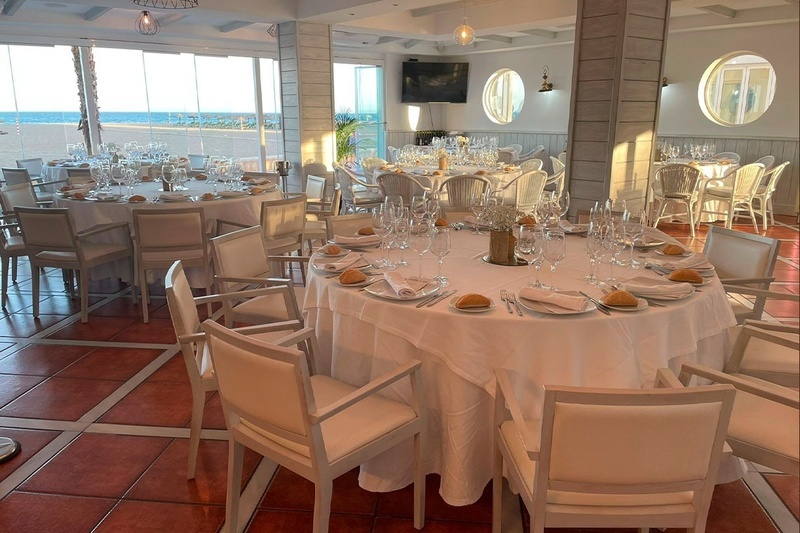 a dining room with tables and chairs set up for a wedding reception