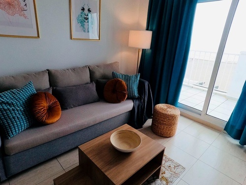 a living room with a couch and a table with a bowl on it