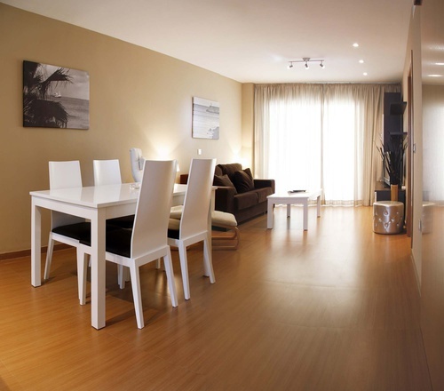 a living room with a dining table and chairs