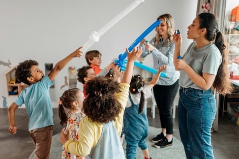 a group of children are watching a movie on a projector screen