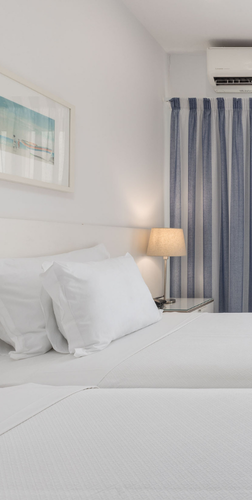 a hotel room with two beds and a balcony