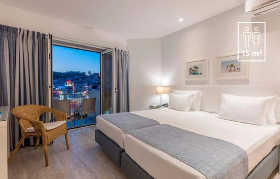 a hotel room with two beds and a chair