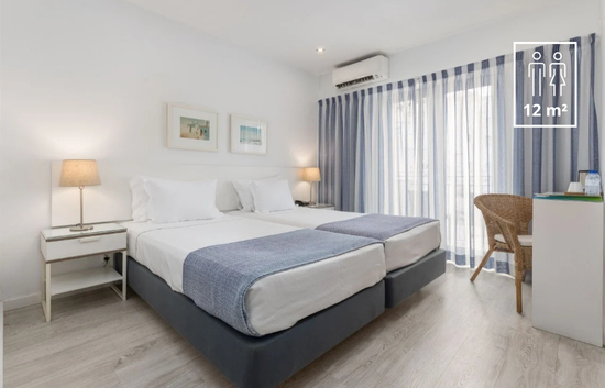 a hotel room with two beds and a sign that says 12 m2