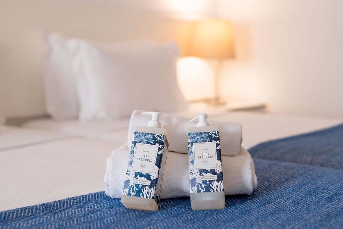 two bottles of sea swash on a bed