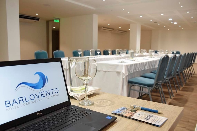 a dell laptop sits on a table in a conference room