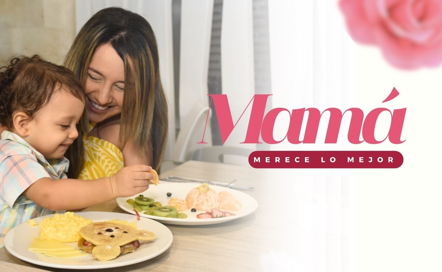 una mujer y un niño están comiendo en una mesa con un cartel que dice mamá merece lo mejor