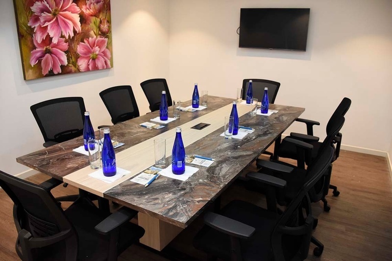 a conference room with bottles of aquafina water on the table