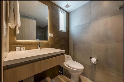 a bathroom with a toilet a sink and a mirror