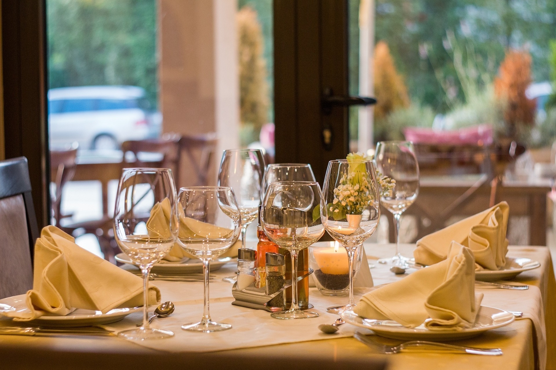 a restaurant table with wine glasses and a candle on it