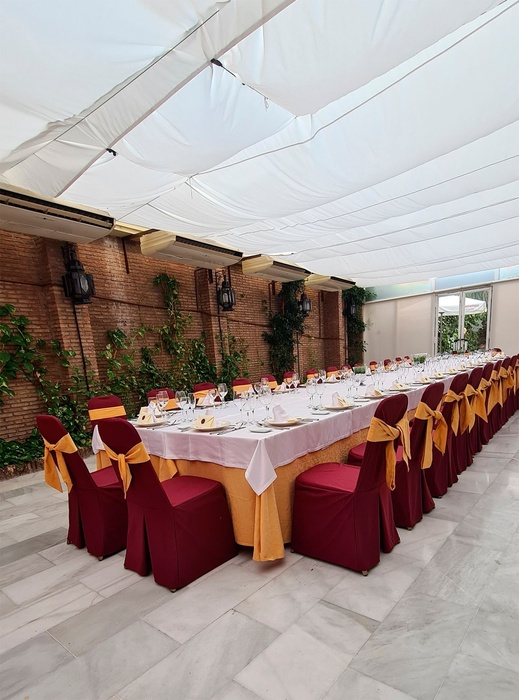 a long table with red and yellow chairs in a restaurant