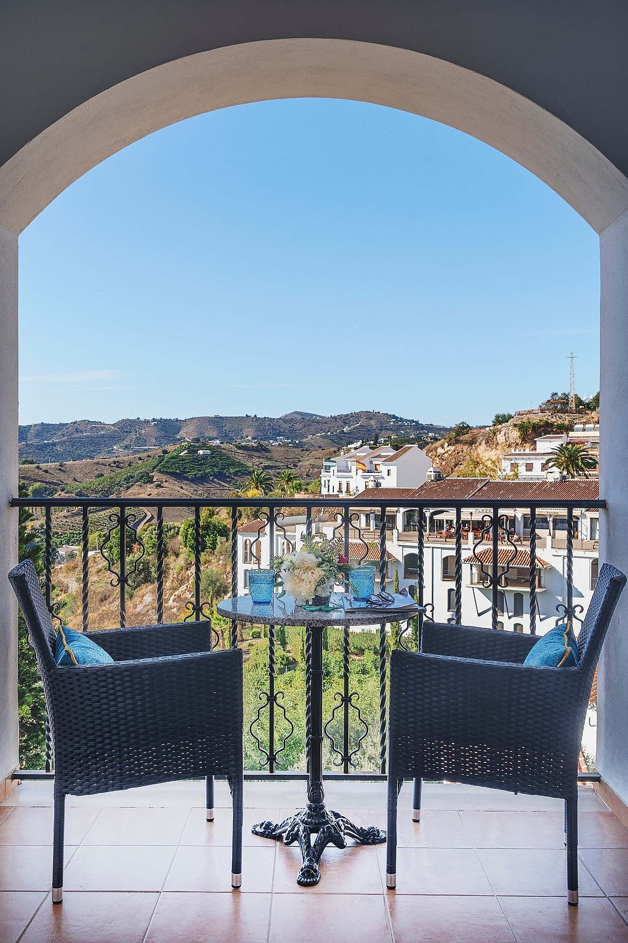 Balcony view from Frigiliana Hotel rooms with table and chairs. Book now on Beneste Hotels official website.