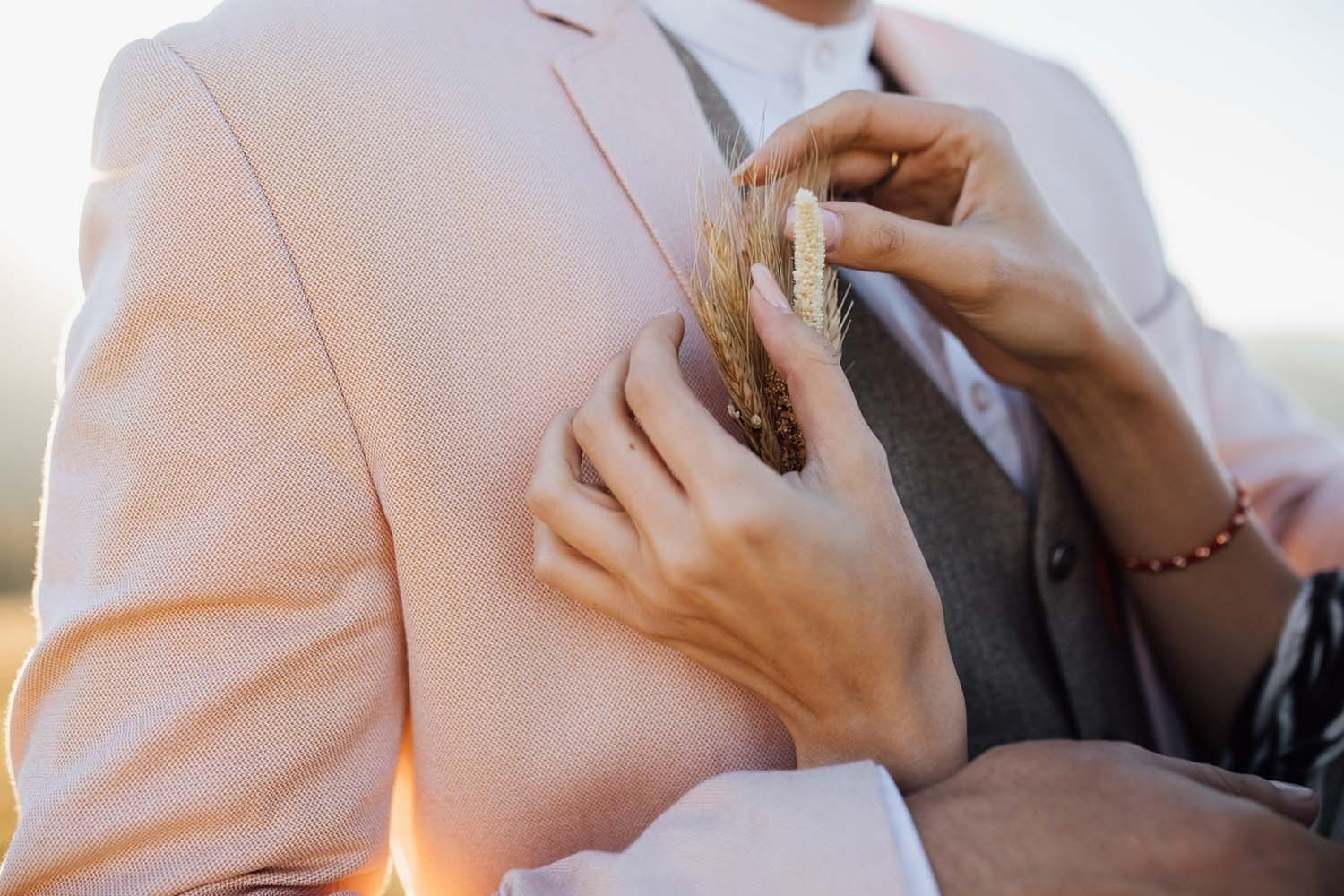 Boutonniere detail on a pink suit lapel at Celebrations | Villa Flamenca | Beneste Hotels | Official Website.