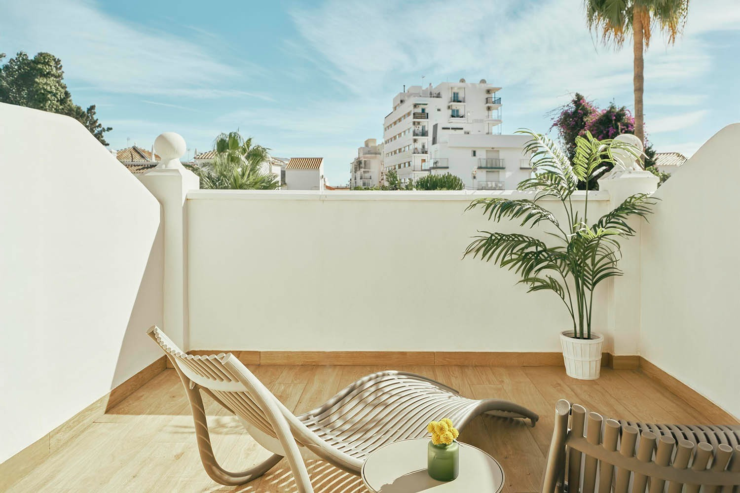 Balcony with chaise lounge, palm, and views. Rooms | Villa Flamenca | Beneste Hotels Official Website