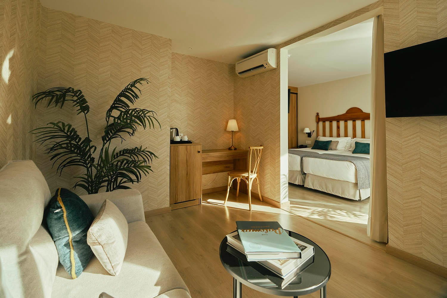 Spacious hotel room with living area, desk, and adjoining bedroom. Book Rooms | Villa Flamenca | Beneste Hotels | Official Website.