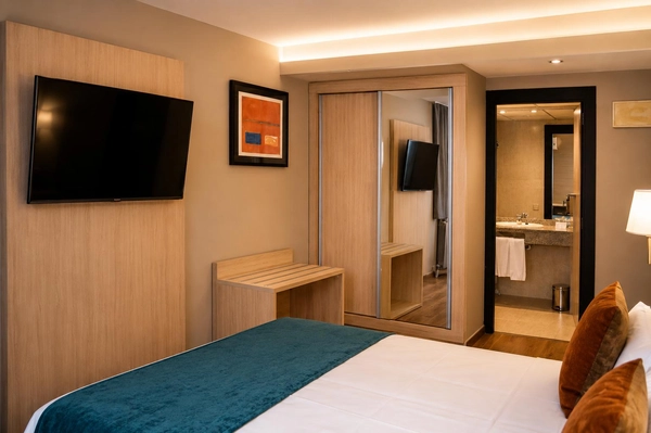 Modern hotel room with TV, wardrobe, and attached bathroom. Hotel Best Andorra Center, Andorra la Vella  | Best Hotels
