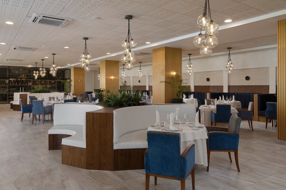 a large dining room with tables and chairs