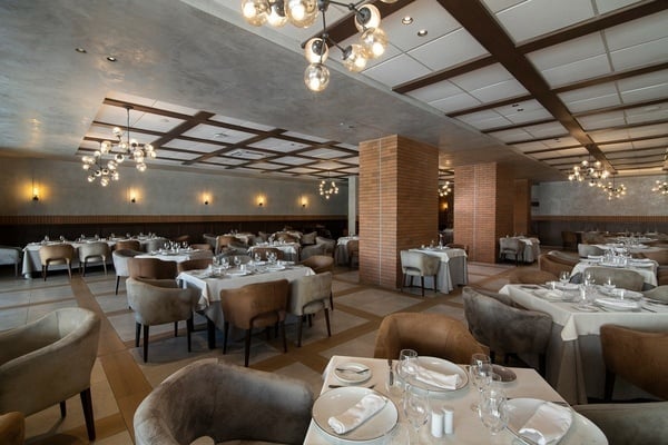 a large dining room with tables and chairs set for dinner