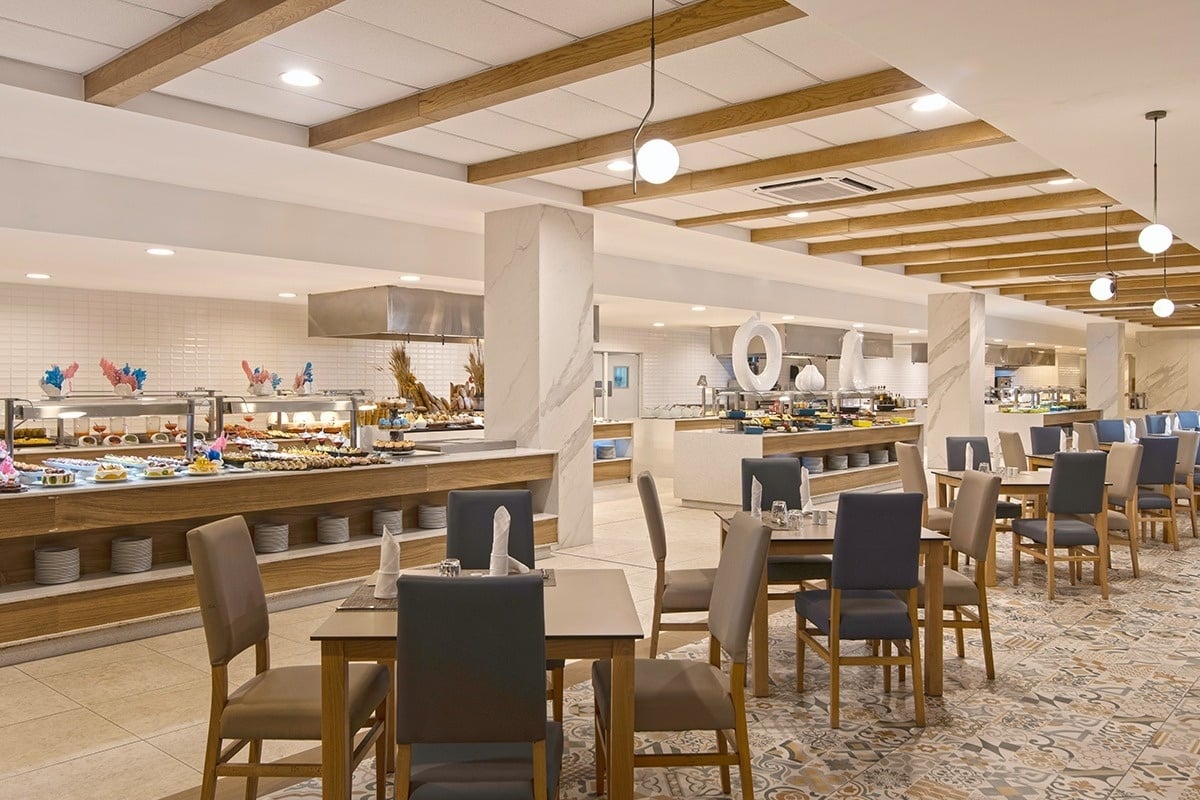 a restaurant with tables and chairs and a buffet