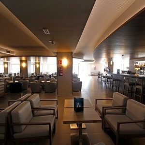 una habitación llena de mesas y sillas con un extintor en la pared