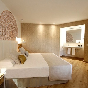 a hotel room with a large bed and a tv