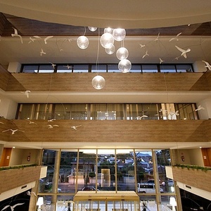 a hotel lobby with birds hanging from the ceiling
