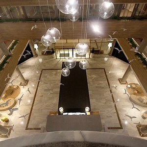 an aerial view of a hotel lobby with seagulls hanging from the ceiling