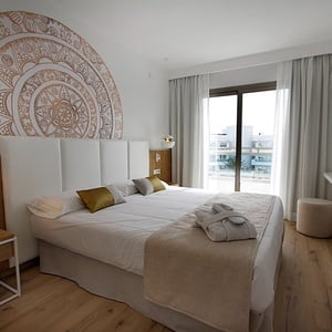 a hotel room with a large bed and a flat screen tv