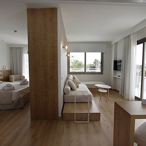 a hotel room with two beds and a couch