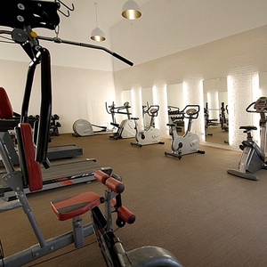 a gym with a treadmill that says ' life fitness ' on it