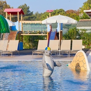 una estatua de un delfín en una piscina con un tobogán