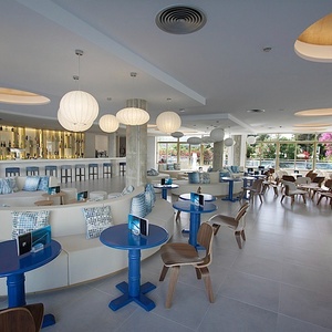 a restaurant with blue and white tables and chairs
