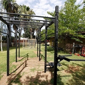 a backyard gym with a wooden building in the background